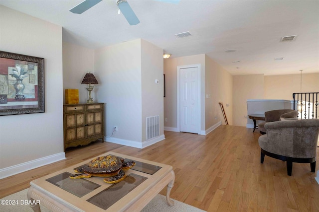 living room featuring light wood-type flooring and ceiling fan