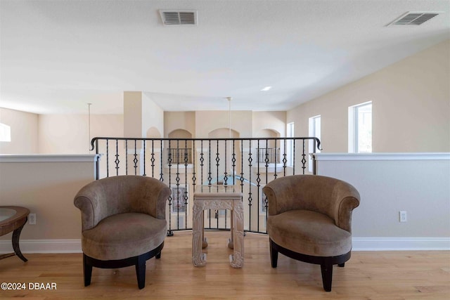 sitting room featuring a notable chandelier and light hardwood / wood-style floors