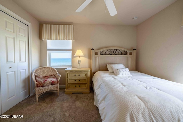 carpeted bedroom with ceiling fan and a closet