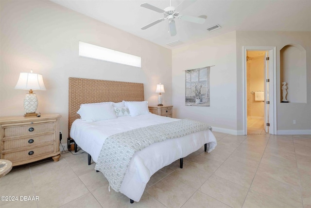 tiled bedroom featuring ensuite bath and ceiling fan