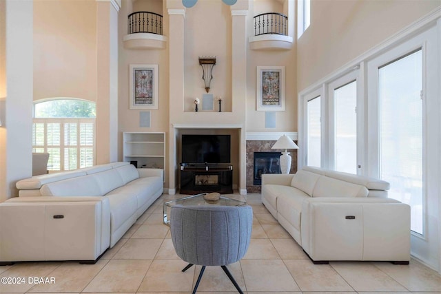 tiled living room with a wealth of natural light and a high ceiling