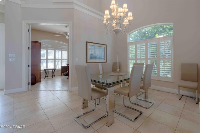 dining space with ceiling fan with notable chandelier, plenty of natural light, and light tile patterned floors