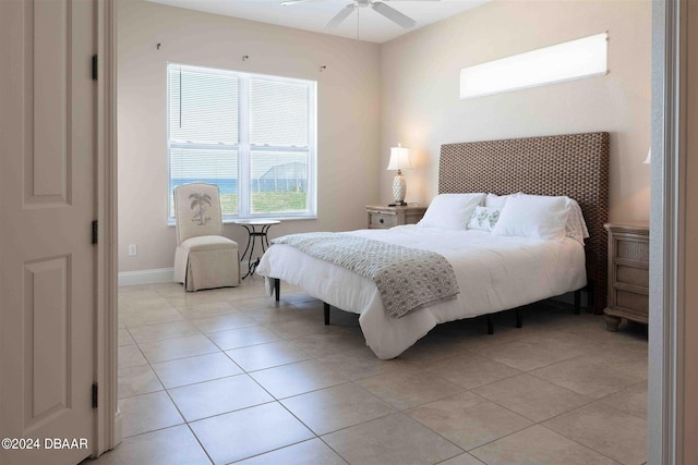 tiled bedroom featuring ceiling fan