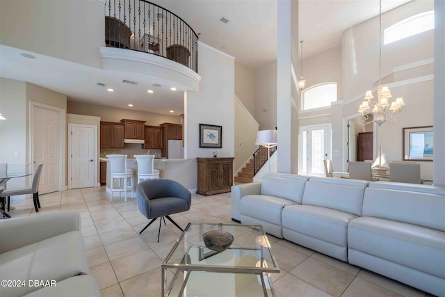 tiled living room with a high ceiling and an inviting chandelier