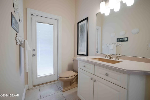 bathroom with vanity, tile patterned flooring, and toilet