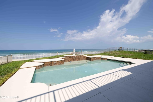 view of pool with a jacuzzi, a water view, and a patio area