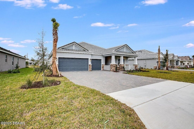 view of front of house with a garage, a front yard, and covered porch