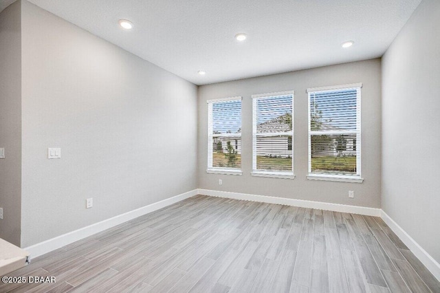 spare room with light wood-type flooring