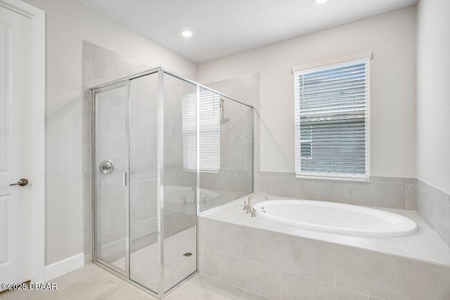 bathroom featuring plus walk in shower and tile patterned floors