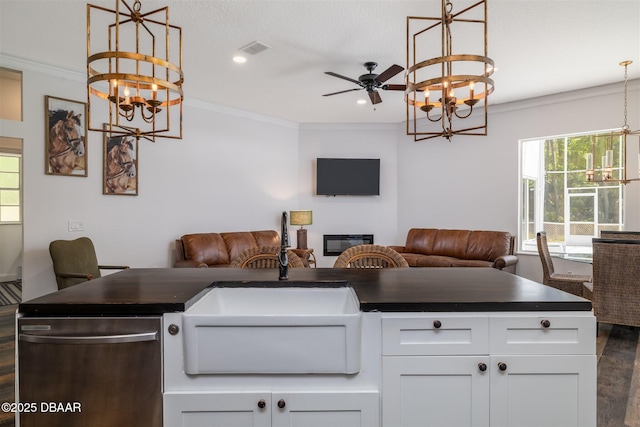 kitchen featuring dark wood finished floors, dark countertops, dishwasher, and open floor plan