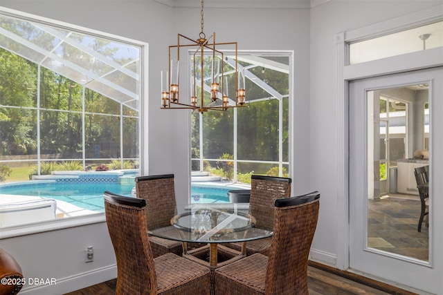 dining room with baseboards, dark wood-style flooring, and a notable chandelier