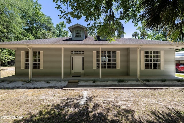 view of front of home with covered porch and roof with shingles