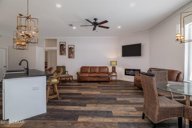 760 Trophy Hunter Trl, New Smyrna Beach, FL 32168 - interior space with recessed lighting, baseboards, ornamental molding, ceiling fan with notable chandelier, and dark wood-type flooring