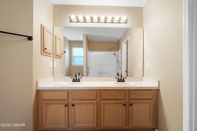 full bathroom featuring double vanity, walk in shower, and a sink