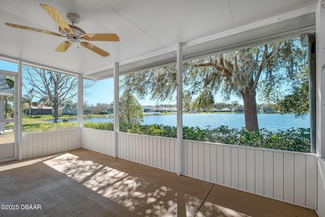 unfurnished sunroom featuring a water view and ceiling fan