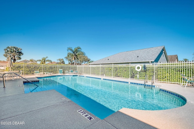 community pool featuring a patio area and fence