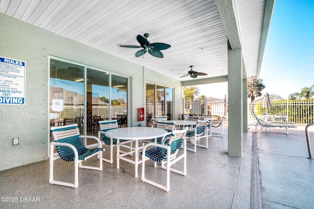 view of patio / terrace featuring a ceiling fan, outdoor dining space, and fence