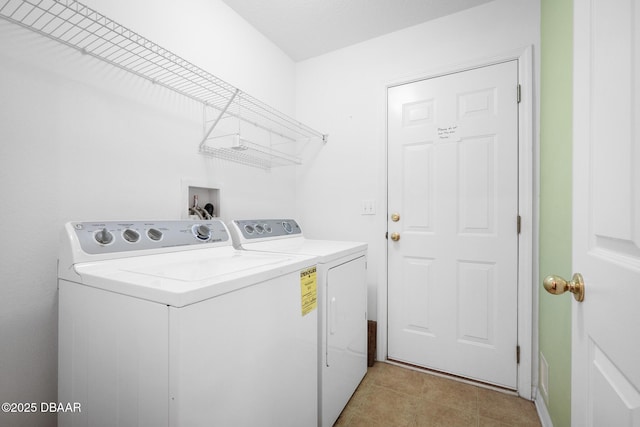 laundry room featuring laundry area, washing machine and clothes dryer, and light tile patterned floors