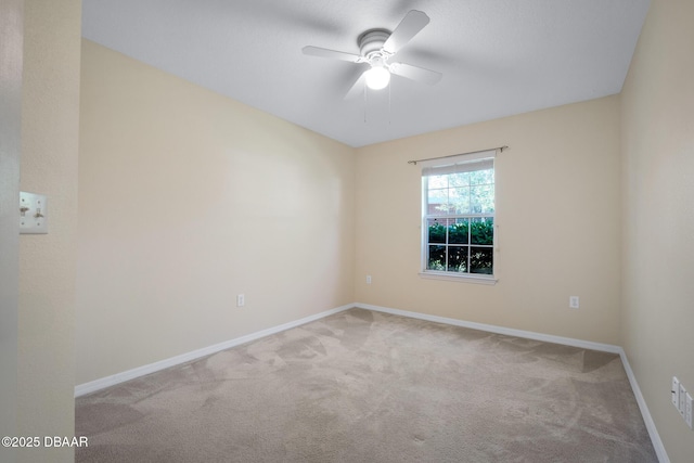 unfurnished room featuring carpet, visible vents, baseboards, and ceiling fan