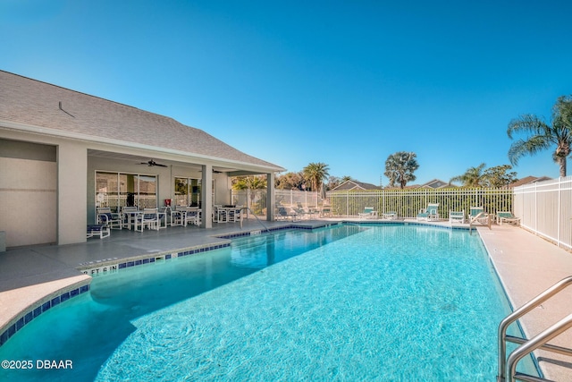 community pool with ceiling fan, a patio area, and fence