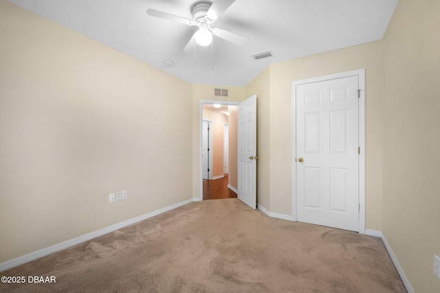 unfurnished bedroom featuring carpet flooring, visible vents, and baseboards