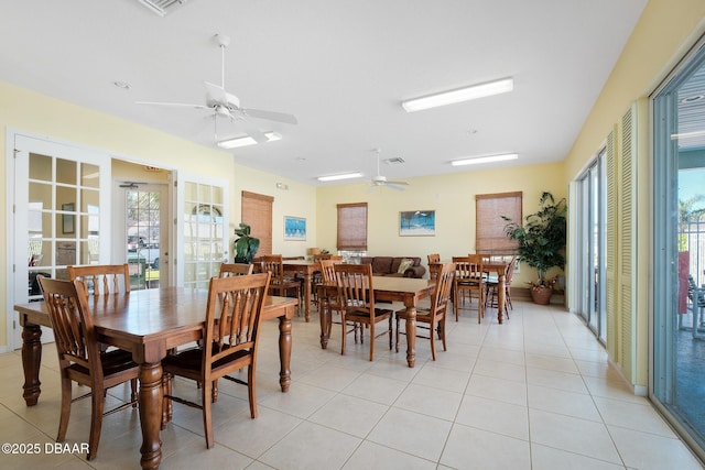 dining space with plenty of natural light, ceiling fan, and light tile patterned flooring