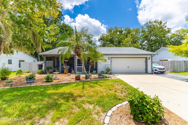 single story home featuring a garage and a front lawn