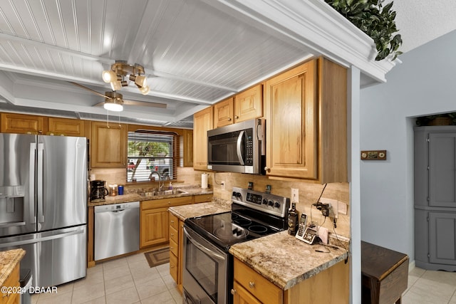 kitchen featuring stainless steel appliances, light tile patterned floors, sink, and decorative backsplash