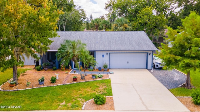 view of front of home featuring a garage and a front lawn