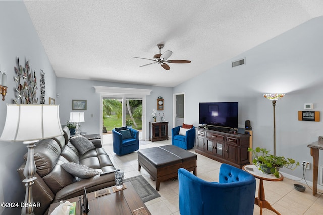 tiled living room with lofted ceiling, a textured ceiling, and ceiling fan