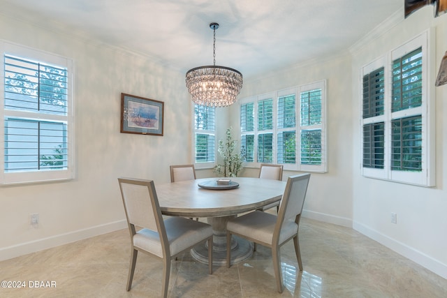 dining room with plenty of natural light, an inviting chandelier, and ornamental molding