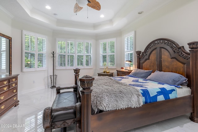 bedroom featuring a tray ceiling, multiple windows, ceiling fan, and crown molding