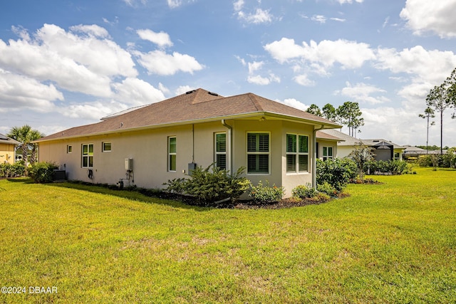 1124 Sea Shell Ct, Daytona Beach, FL 32124 - back of house featuring stucco siding, a yard, and cooling unit