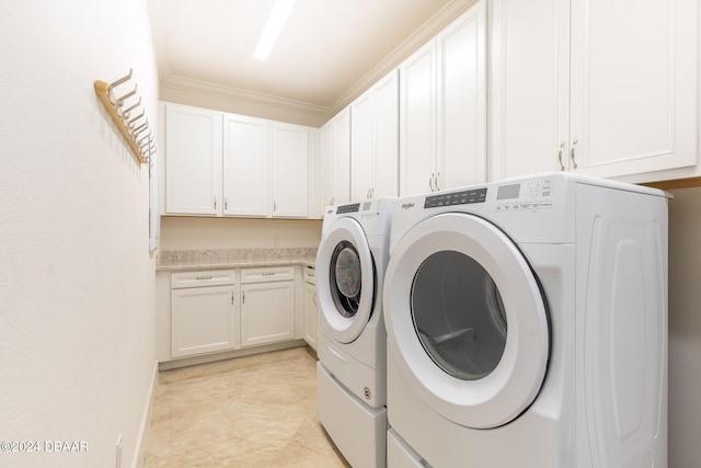 laundry area featuring cabinets, washer and clothes dryer, and ornamental molding