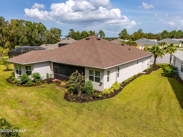 back of property featuring a yard and a lanai