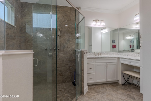 bathroom featuring an enclosed shower, vanity, and ornamental molding