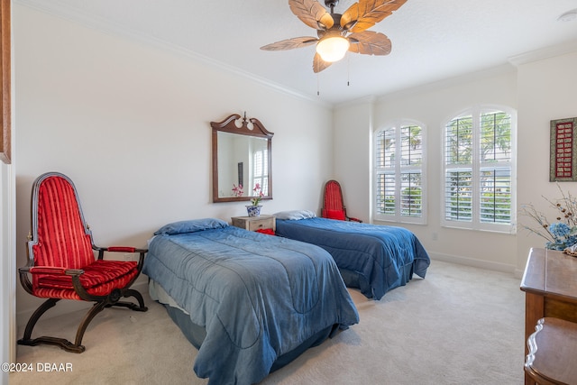 carpeted bedroom with ornamental molding and ceiling fan