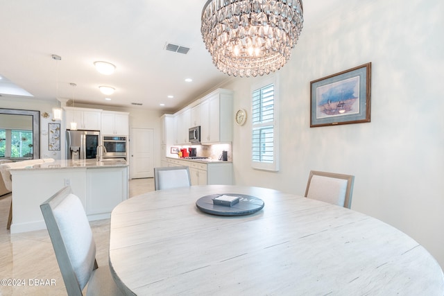 dining area with a healthy amount of sunlight, a chandelier, and light tile patterned floors