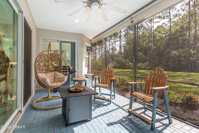 sunroom / solarium featuring ceiling fan and plenty of natural light