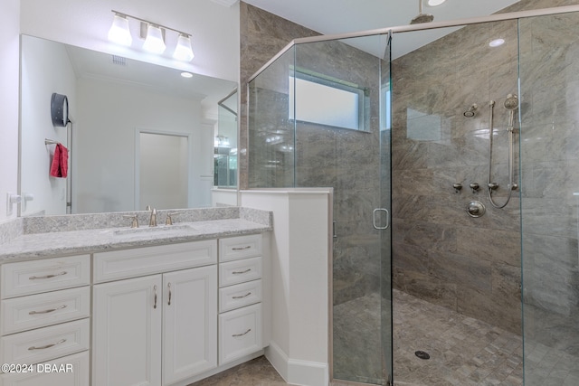 bathroom with walk in shower and vanity