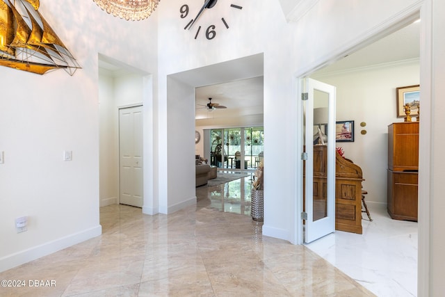 1124 Sea Shell Ct, Daytona Beach, FL 32124 - corridor featuring a towering ceiling, light marble finish floors, crown molding, and baseboards
