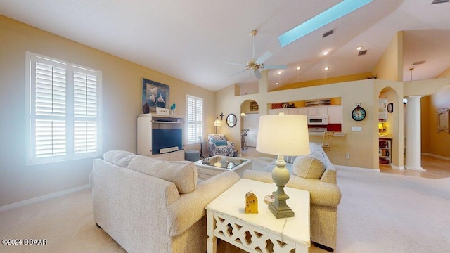 living room with decorative columns, lofted ceiling, light carpet, and ceiling fan