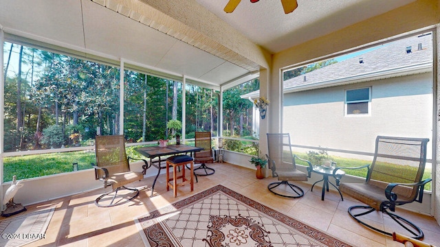 sunroom / solarium featuring ceiling fan