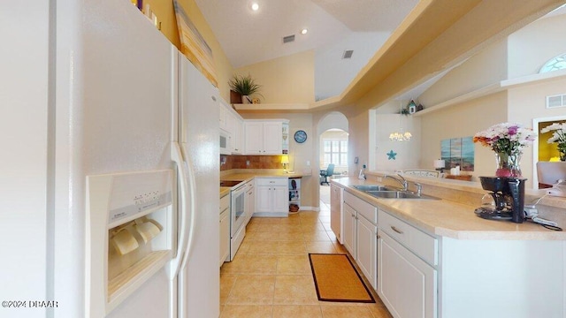 kitchen featuring sink, light tile patterned floors, high vaulted ceiling, white appliances, and white cabinets