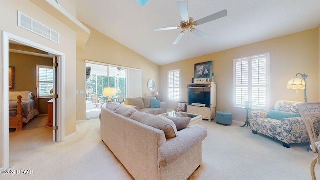 carpeted living room featuring high vaulted ceiling, ceiling fan, and plenty of natural light