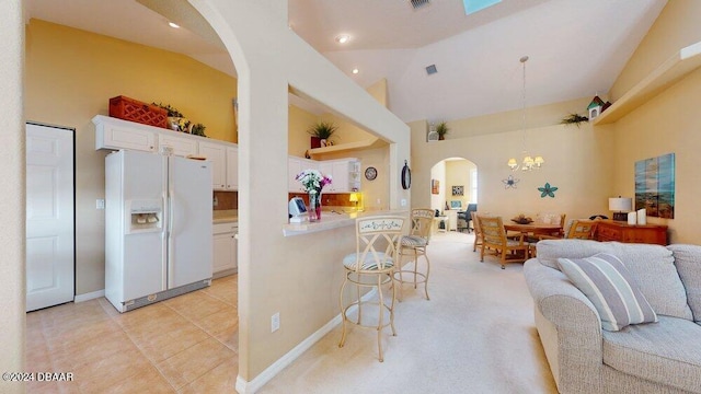 living room featuring high vaulted ceiling, a notable chandelier, and light tile patterned flooring