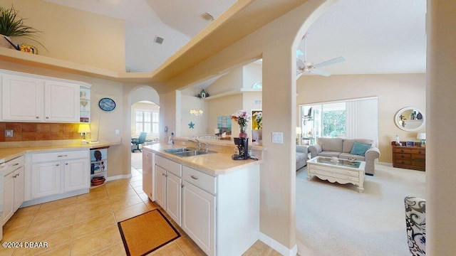 kitchen featuring a wealth of natural light and white cabinetry