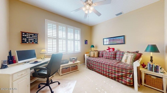 home office with ceiling fan and light carpet