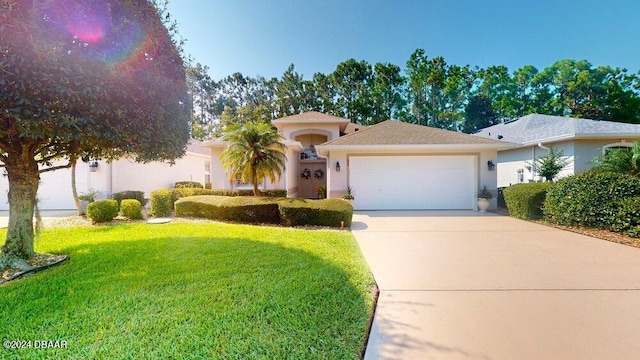 view of front of property with a garage and a front lawn