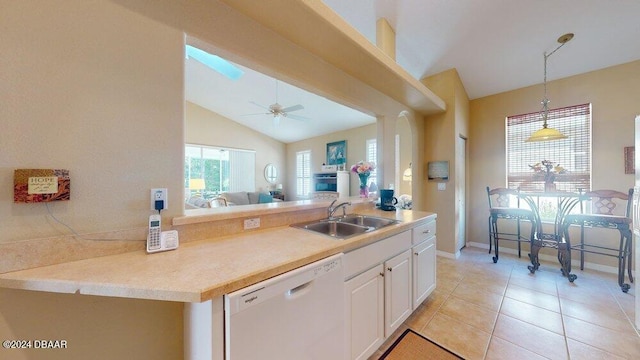 kitchen featuring light tile patterned flooring, sink, white cabinets, dishwasher, and vaulted ceiling